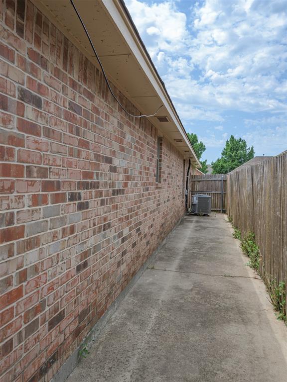 8409 NW 106th St, Oklahoma City, OK 73162 - view of side of property with brick siding and a cooling unit