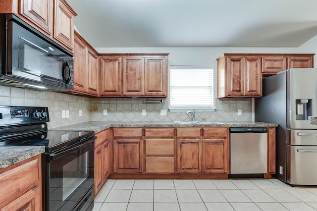 2113 SE 8th St, Moore, OK 73160 - kitchen featuring black appliances, decorative backsplash, brown cabinets, and light tile patterned flooring