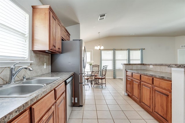 2113 SE 8th St, Moore, OK 73160 - kitchen featuring lofted ceiling, dishwasher, light tile patterned flooring, brown cabinets, and tasteful backsplash