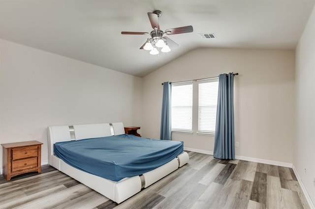 2113 SE 8th St, Moore, OK 73160 - bedroom with lofted ceiling, light wood-style floors, and a ceiling fan