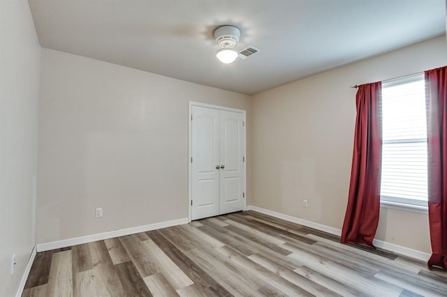 2113 SE 8th St, Moore, OK 73160 - spare room featuring light wood-style flooring and healthy amount of natural light