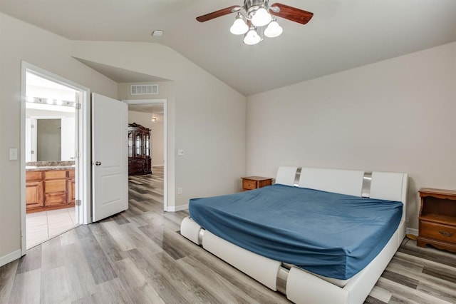 2113 SE 8th St, Moore, OK 73160 - bedroom featuring lofted ceiling, light wood-style floors, connected bathroom, and ceiling fan