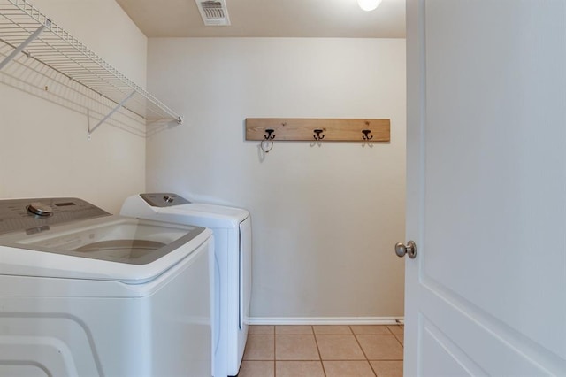 2113 SE 8th St, Moore, OK 73160 - laundry room featuring washing machine and dryer and light tile patterned flooring