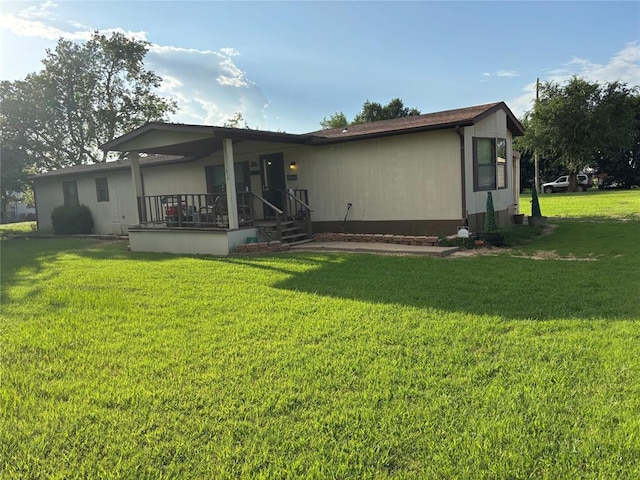 515 Logan Ave, Cashion, OK 73016 - rear view of house featuring a lawn and covered porch