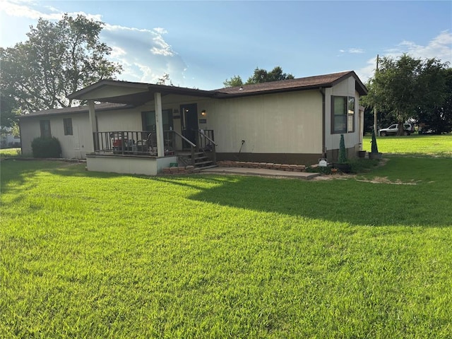 515 Logan Ave, Cashion, OK 73016 - back of house with a lawn and covered porch
