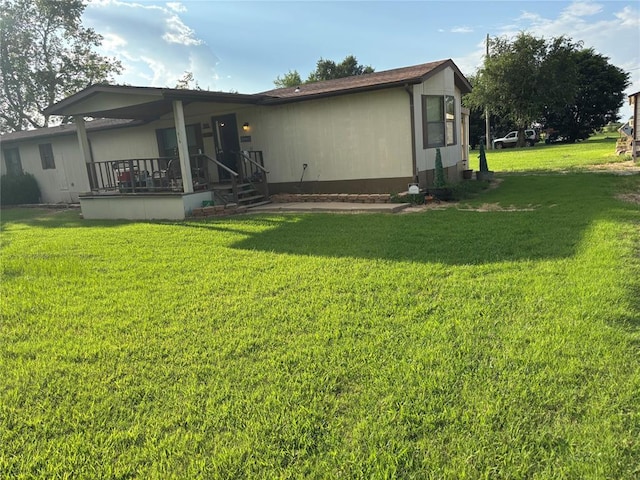 515 Logan Ave, Cashion, OK 73016 - rear view of house featuring a yard and covered porch