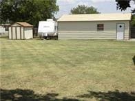 515 Logan Ave, Cashion, OK 73016 - view of grassy yard with a storage unit