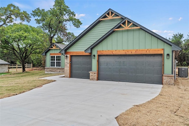 1244 Layla Ln, Blanchard, OK 73010 - view of front facade with an attached garage, brick siding, board and batten siding, and concrete driveway