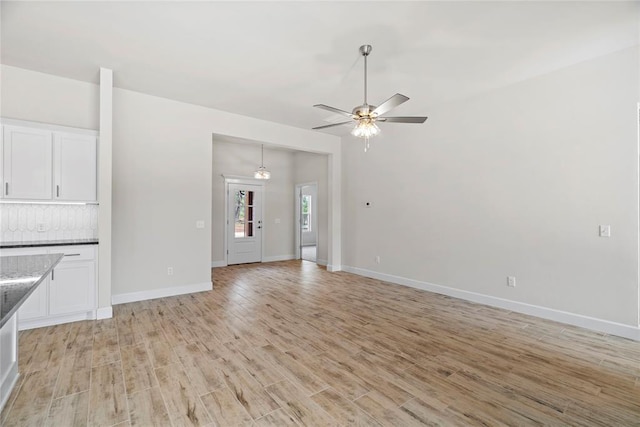 1244 Layla Ln, Blanchard, OK 73010 - unfurnished living room featuring light wood-style flooring and ceiling fan