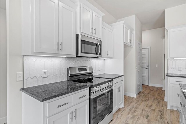 1244 Layla Ln, Blanchard, OK 73010 - kitchen featuring stainless steel appliances, light wood-style floors, white cabinets, and decorative backsplash