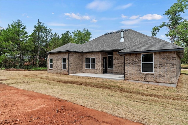 1244 Layla Ln, Blanchard, OK 73010 - back of house with a patio, brick siding, roof with shingles, and a yard
