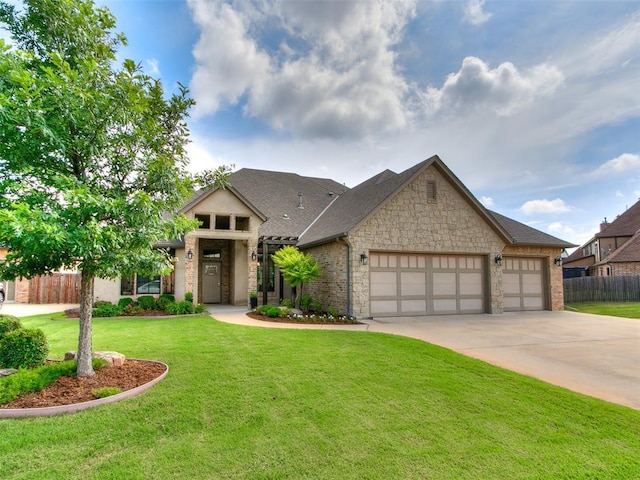 609 Newport Bridge Dr, Edmond, OK 73034 - view of front facade featuring an attached garage, concrete driveway, stone siding, and roof with shingles