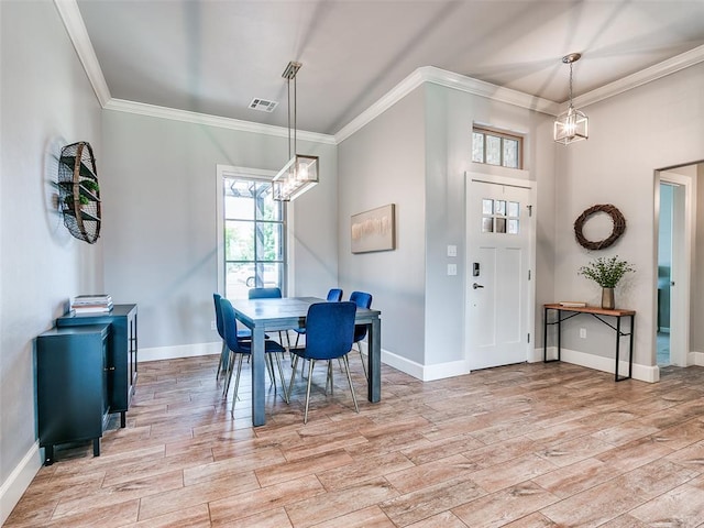 609 Newport Bridge Dr, Edmond, OK 73034 - dining room featuring a chandelier, ornamental molding, and light wood-style floors