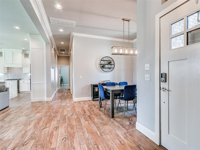 609 Newport Bridge Dr, Edmond, OK 73034 - foyer with crown molding, light wood finished floors, a chandelier, and recessed lighting