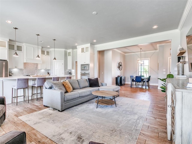 609 Newport Bridge Dr, Edmond, OK 73034 - living area with ornamental molding, light wood finished floors, and recessed lighting