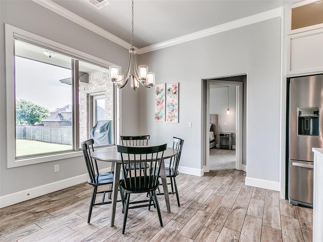 609 Newport Bridge Dr, Edmond, OK 73034 - dining space featuring crown molding, a chandelier, and light wood finished floors