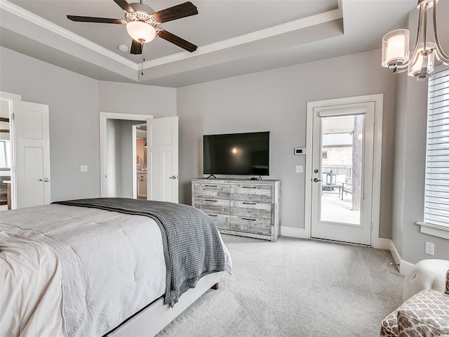 609 Newport Bridge Dr, Edmond, OK 73034 - carpeted bedroom with a tray ceiling, access to exterior, ornamental molding, a chandelier, and ceiling fan