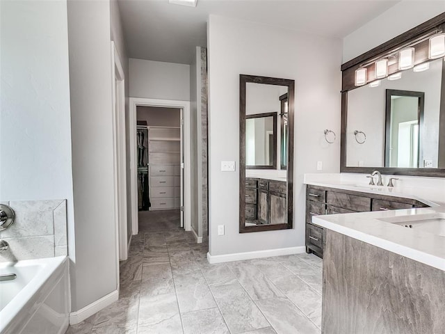 609 Newport Bridge Dr, Edmond, OK 73034 - full bath with a garden tub, marble look tile flooring, vanity, and a walk in closet