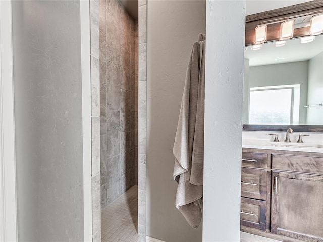 609 Newport Bridge Dr, Edmond, OK 73034 - full bathroom with a textured wall, a walk in shower, and vanity
