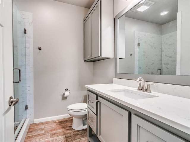 609 Newport Bridge Dr, Edmond, OK 73034 - bathroom with vanity, a stall shower, wood finished floors, and recessed lighting