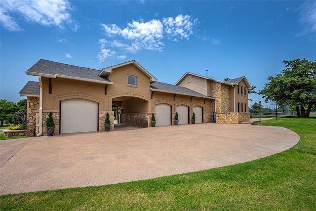 1701 Woodhill Rd, Edmond, OK 73025 - view of front of property featuring stone siding, an attached garage, stucco siding, and concrete driveway