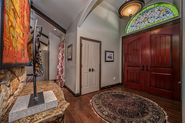 1701 Woodhill Rd, Edmond, OK 73025 - foyer with dark wood-style flooring, crown molding, and a towering ceiling