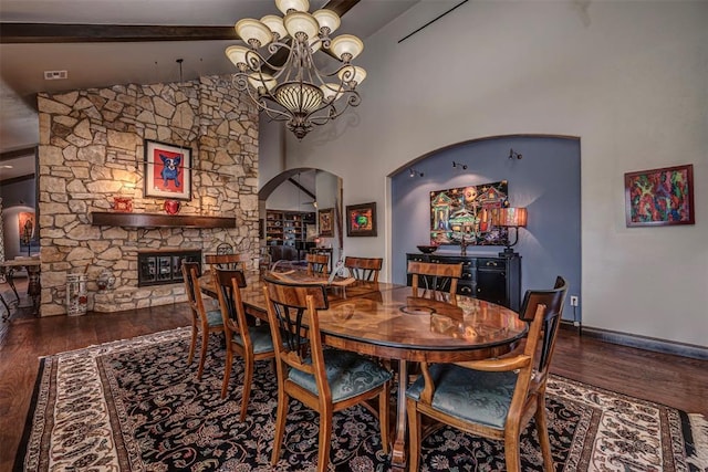 1701 Woodhill Rd, Edmond, OK 73025 - dining room with arched walkways, a chandelier, wood finished floors, beam ceiling, and high vaulted ceiling