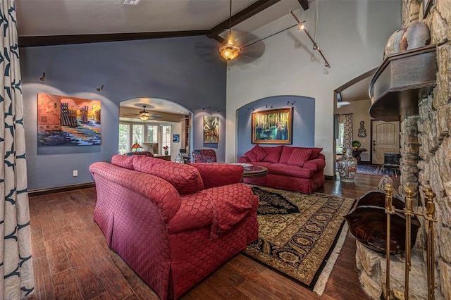1701 Woodhill Rd, Edmond, OK 73025 - living area with a ceiling fan, arched walkways, beamed ceiling, wood finished floors, and high vaulted ceiling
