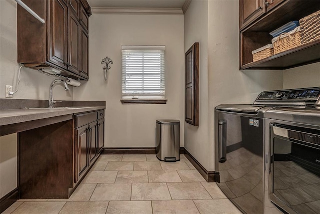 1701 Woodhill Rd, Edmond, OK 73025 - laundry area featuring cabinet space, independent washer and dryer, crown molding, and light tile patterned floors
