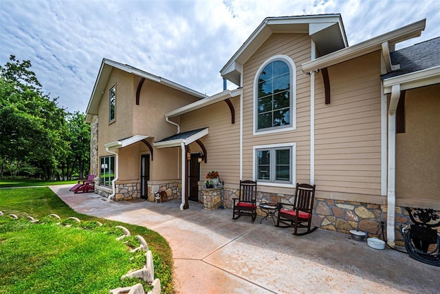 1701 Woodhill Rd, Edmond, OK 73025 - rear view of house featuring a lawn, a patio, and stucco siding