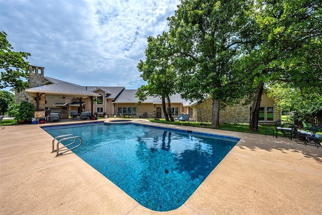 1701 Woodhill Rd, Edmond, OK 73025 - view of swimming pool with ceiling fan, a patio, and a pool with connected hot tub