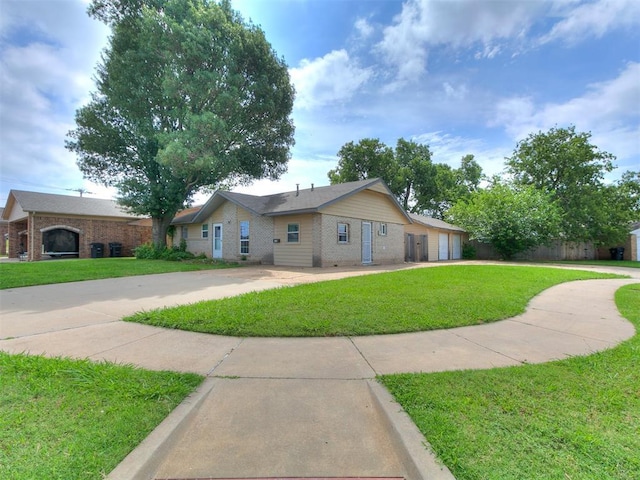 650 NW 5th St, Moore, OK 73160 - ranch-style house featuring brick siding, driveway, and a front lawn