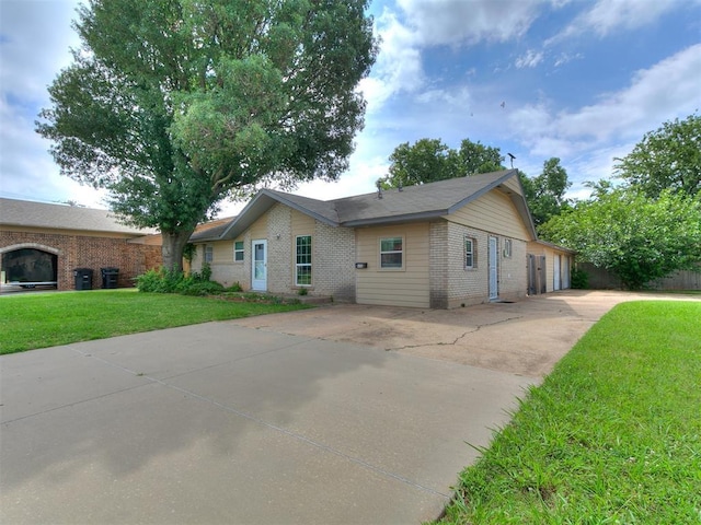 650 NW 5th St, Moore, OK 73160 - view of front of home featuring brick siding and a front yard