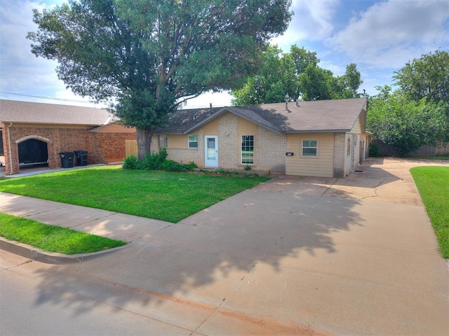 650 NW 5th St, Moore, OK 73160 - single story home featuring brick siding, driveway, and a front lawn