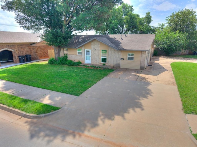 650 NW 5th St, Moore, OK 73160 - single story home with brick siding and driveway