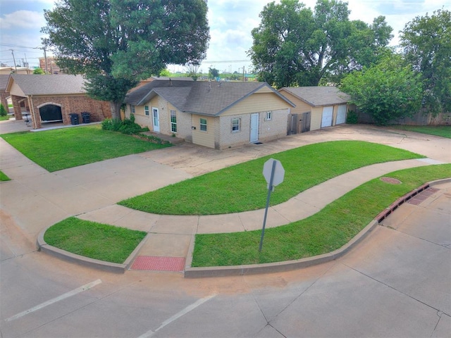 650 NW 5th St, Moore, OK 73160 - ranch-style house featuring concrete driveway, a front lawn, and brick siding
