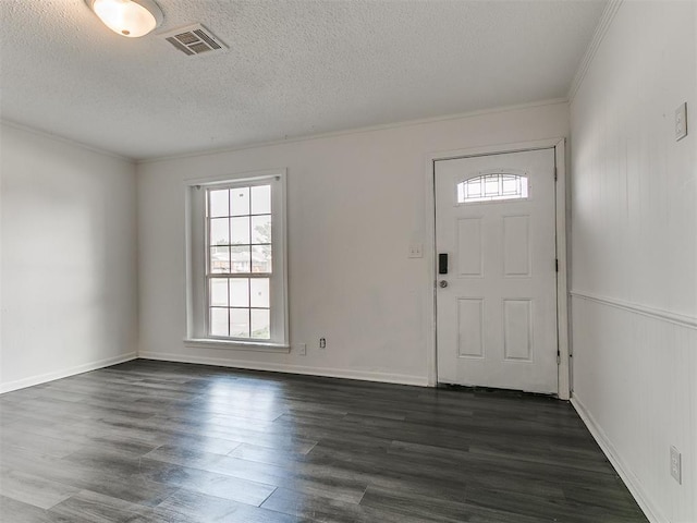 650 NW 5th St, Moore, OK 73160 - entrance foyer featuring healthy amount of natural light, dark wood-style flooring, crown molding, and a textured ceiling