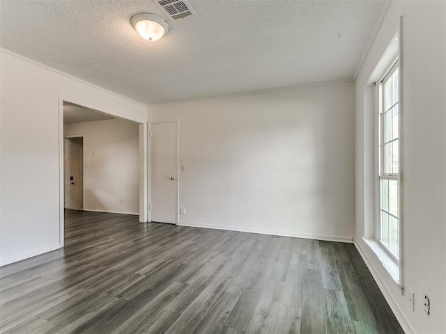 650 NW 5th St, Moore, OK 73160 - empty room with dark wood-type flooring, a textured ceiling, and crown molding