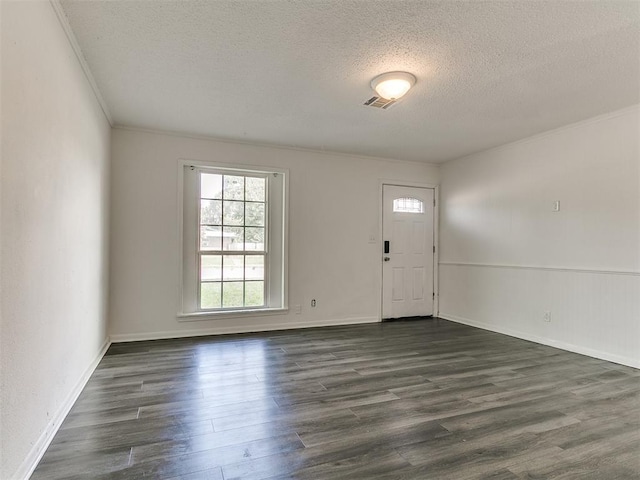 650 NW 5th St, Moore, OK 73160 - entrance foyer with a textured ceiling, dark wood-type flooring, and ornamental molding