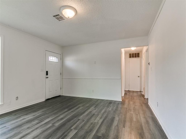 650 NW 5th St, Moore, OK 73160 - foyer featuring a textured ceiling, dark wood finished floors, and crown molding