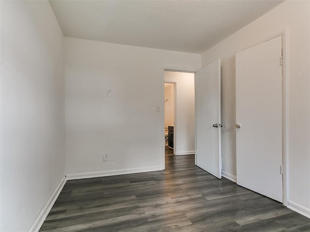 650 NW 5th St, Moore, OK 73160 - unfurnished bedroom featuring dark wood-type flooring and baseboards