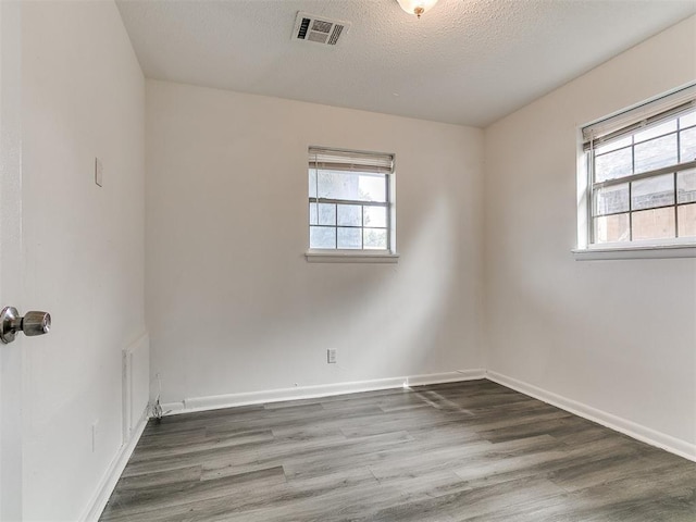 650 NW 5th St, Moore, OK 73160 - spare room featuring wood finished floors and a textured ceiling