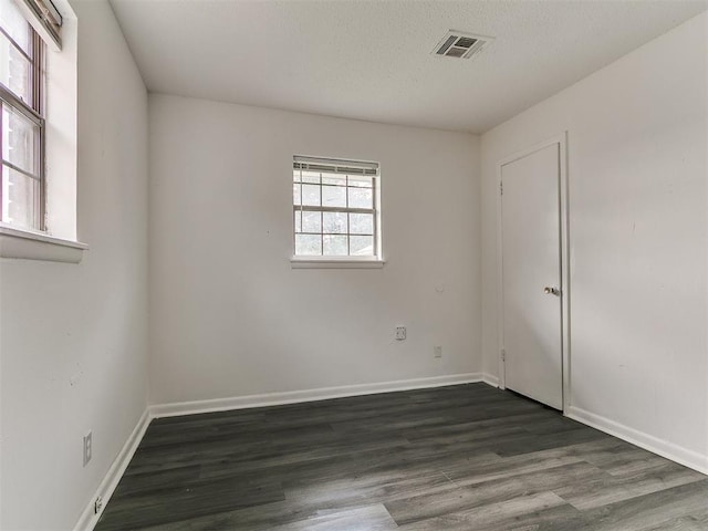 650 NW 5th St, Moore, OK 73160 - empty room featuring dark wood-style flooring and a textured ceiling