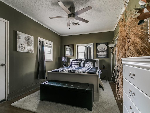 650 NW 5th St, Moore, OK 73160 - bedroom featuring ornamental molding, a textured ceiling, wood finished floors, and ceiling fan