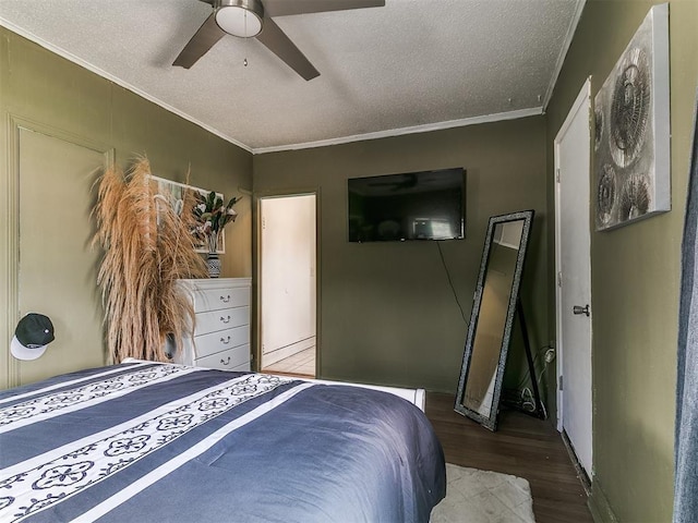 650 NW 5th St, Moore, OK 73160 - bedroom featuring wood finished floors, a textured ceiling, ornamental molding, and a ceiling fan