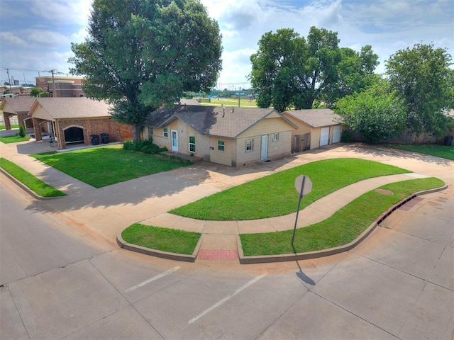 650 NW 5th St, Moore, OK 73160 - ranch-style house with a front yard, a garage, concrete driveway, and brick siding