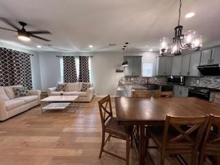 1727 NW 31st St, Oklahoma City, OK 73118 - dining room with a ceiling fan, a chandelier, light wood finished floors, and recessed lighting