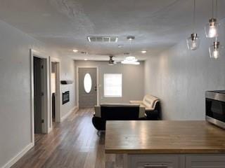 1727 NW 31st St, Oklahoma City, OK 73118 - kitchen with dark wood-style floors, stainless steel microwave, and gray cabinets