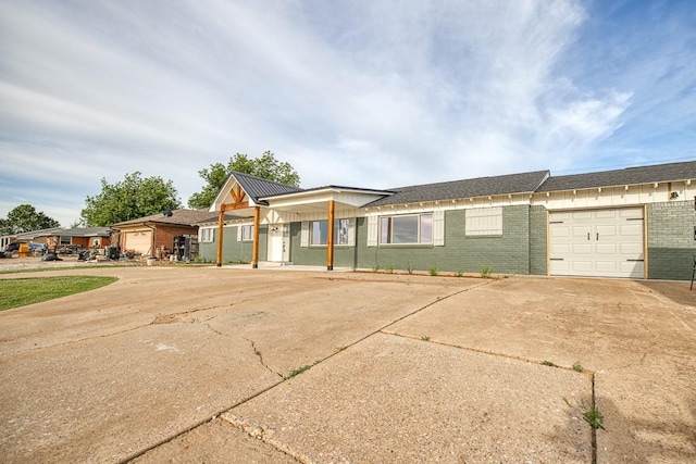1212 S Main St, Kingfisher, OK 73750 - view of front facade featuring brick siding, a garage, and concrete driveway