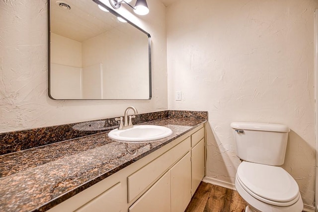 1212 S Main St, Kingfisher, OK 73750 - half bath featuring vanity, wood finished floors, and a textured wall